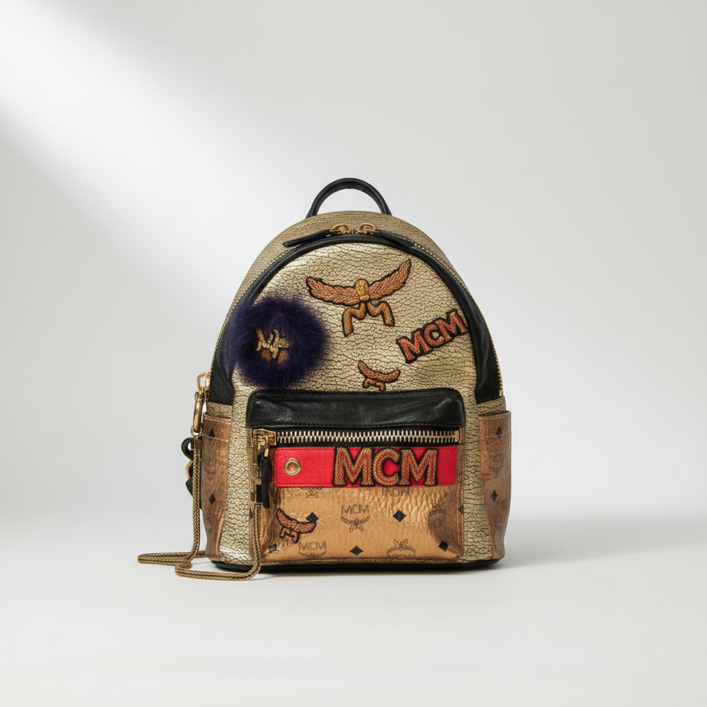 MCM Visetos Stark Insignia Women's Coated Canvas,Leather Backpack Gold,Black