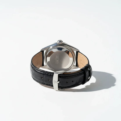 tokyopieces.com vintage Rolex Oysterdate Precision watch showing the stainless steel case back and black leather strap.