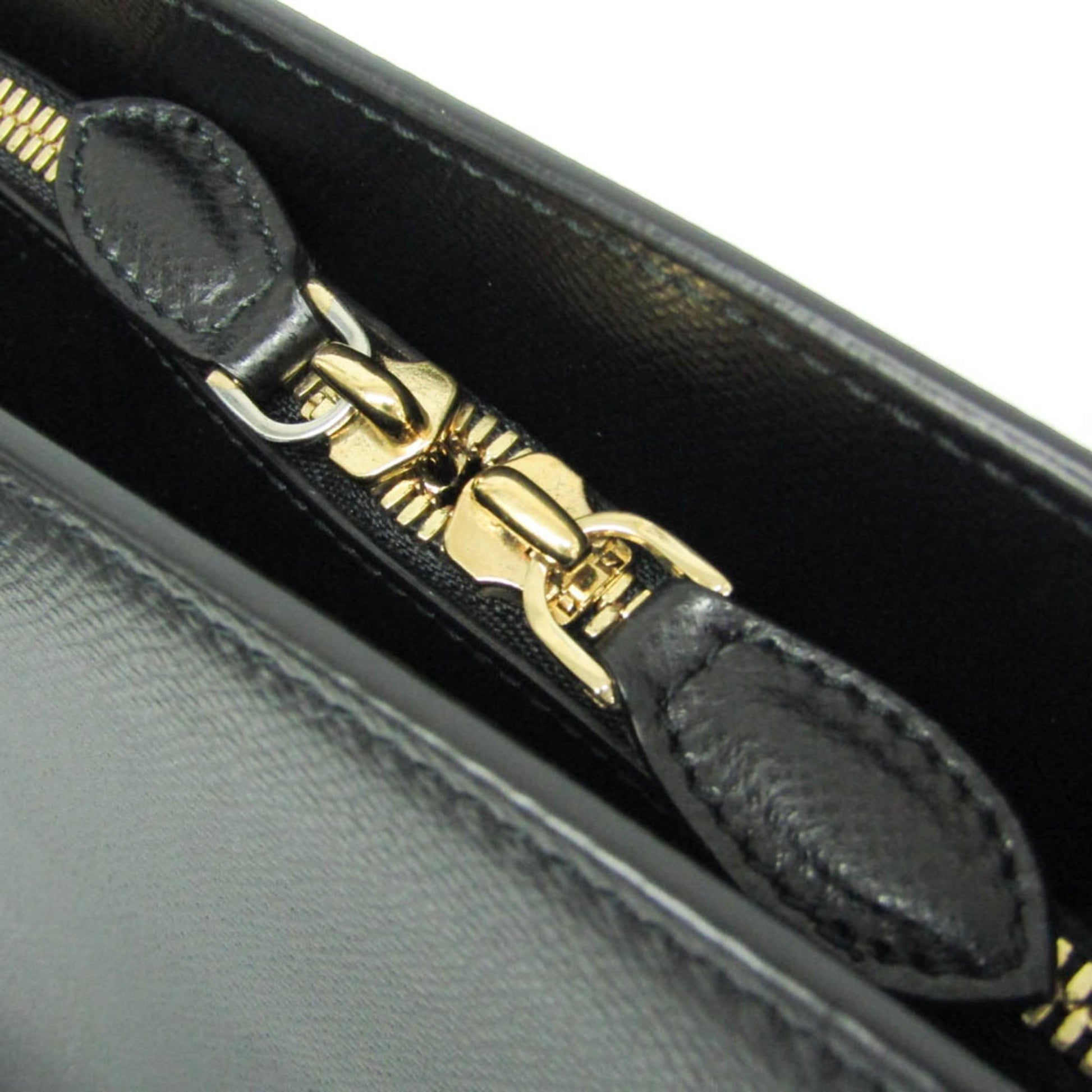 Close-up of the gold-tone zipper on a black leather Salvatore Ferragamo Today tote bag from tokyopieces.com.