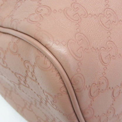 Gucci Guccissima blush pink leather Boston bag with embossed monogram detail.