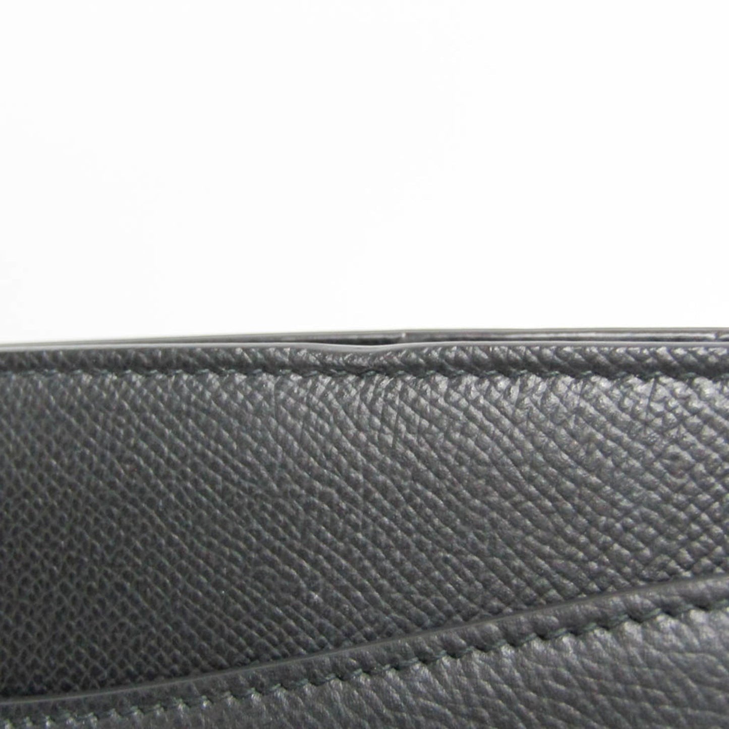 Close-up of black textured leather on a tokyopieces.com Salvatore Ferragamo Today tote bag showing fine stitching.